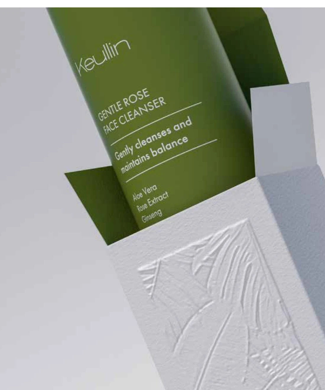 Close-up of a KEULLIN carton with embossed botanical detail and green container